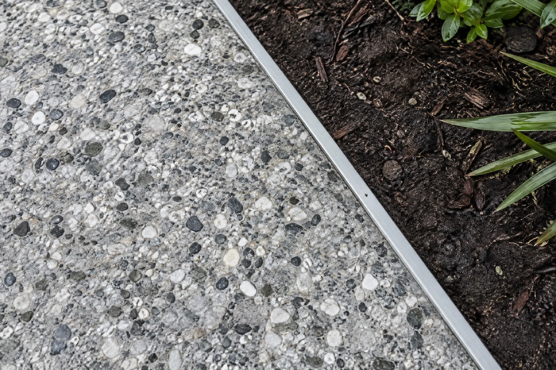 Illustrative exposed-aggregate walkway with a clear garden edge