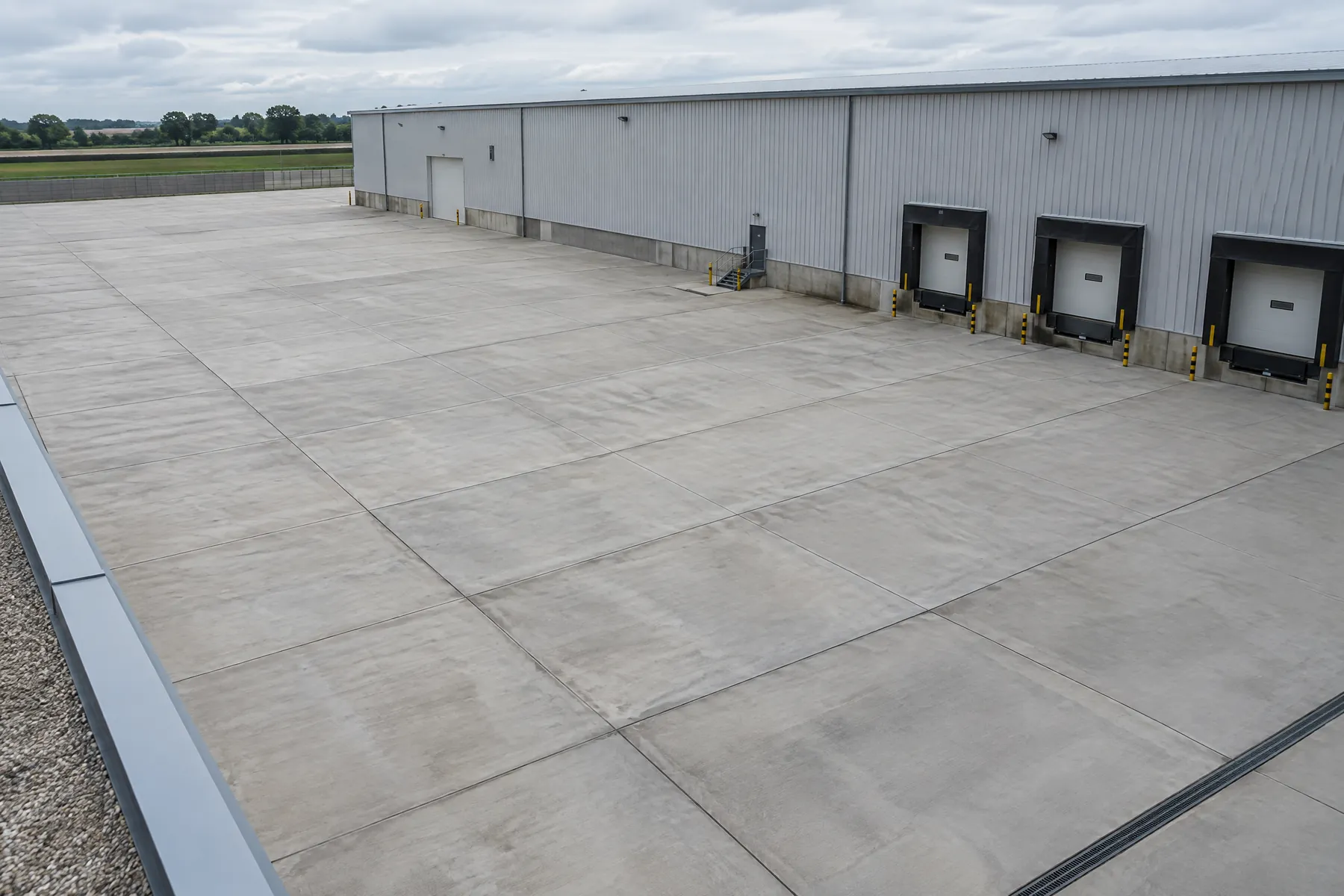 Illustrative concrete commercial loading apron with visible expansion joints