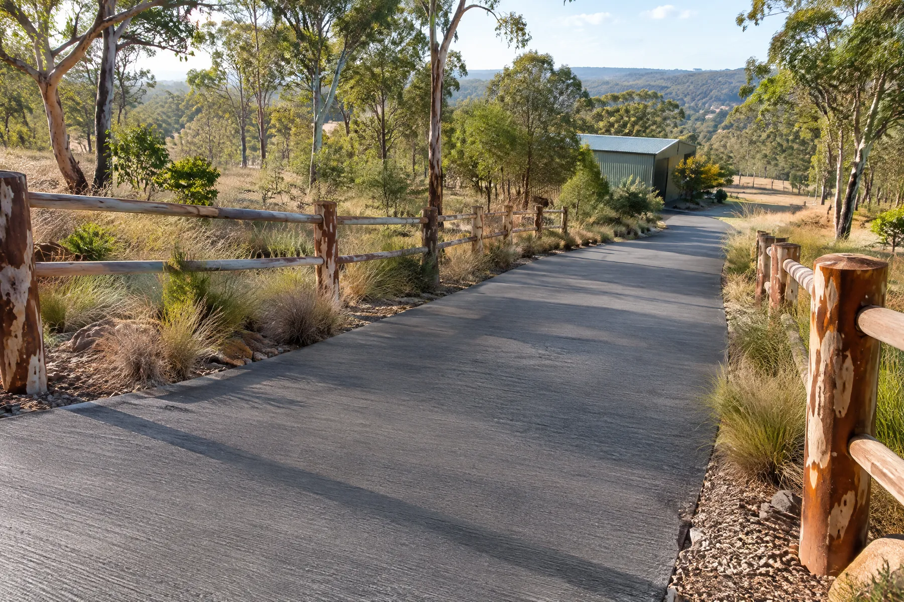 Illustrative plain concrete driveway from an elevated entrance-side angle